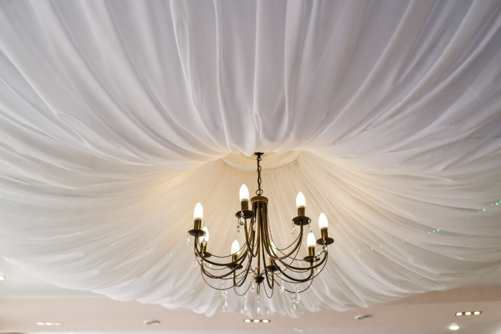 Tent draping around chandelier