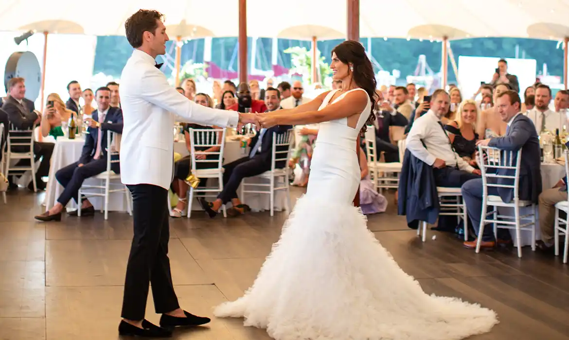 Bride & groom dancing on a dark wood dance floor