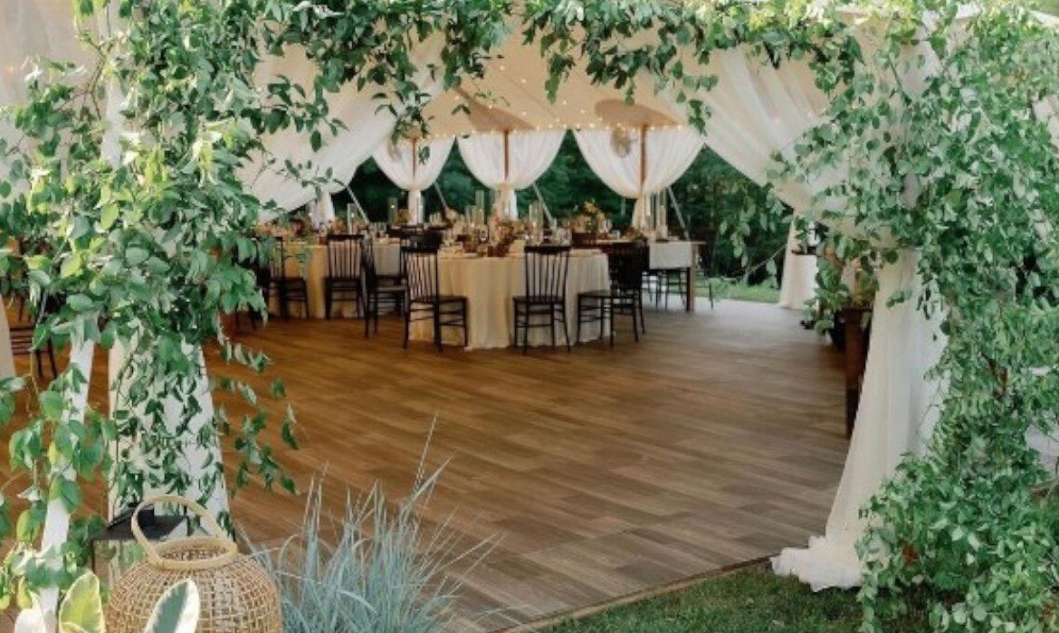 looking inside the tent with wood flooring and draping