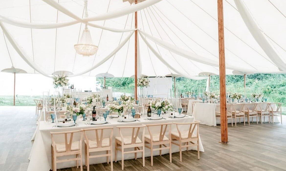 tent with overhead white draping a chandelier