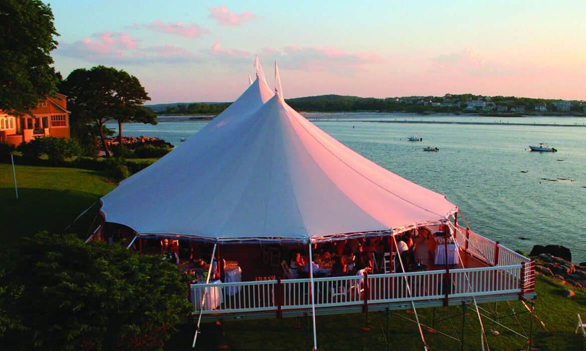 Leveled floor with wedding tent on it near ocean